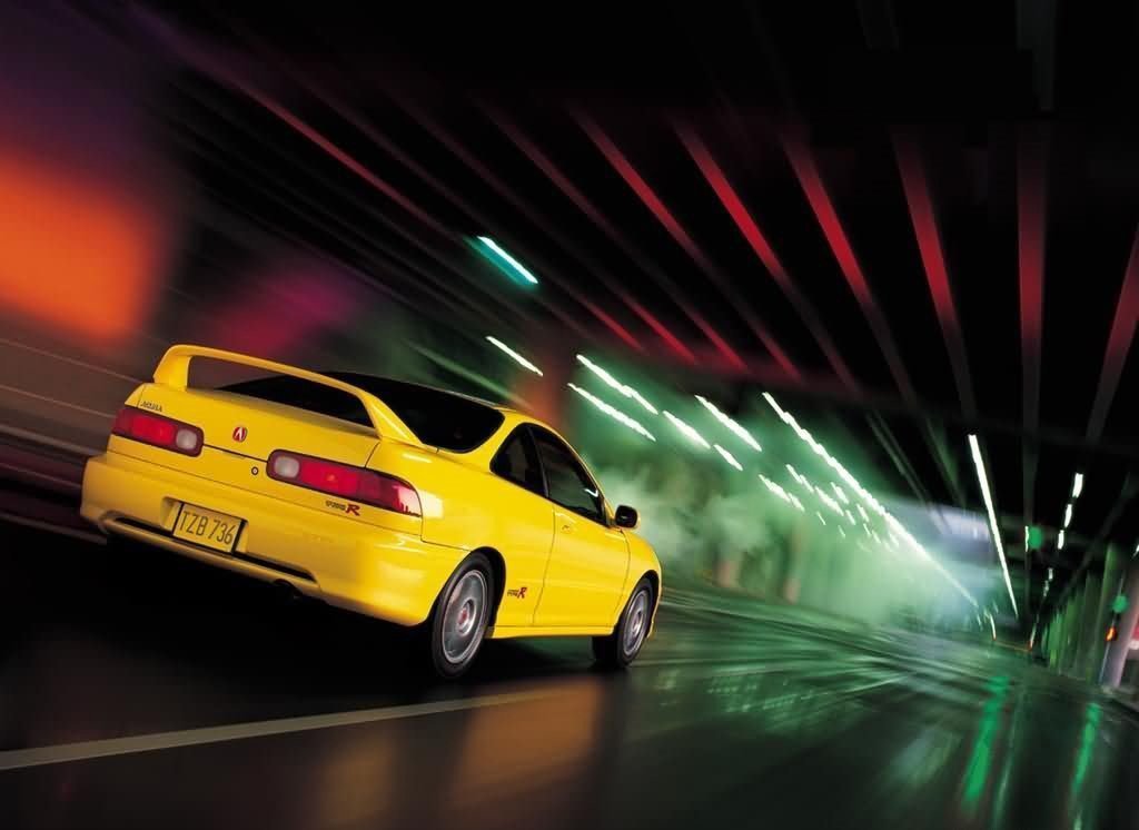 A Phoenix Yellow Integra Type R driving through a tunnel